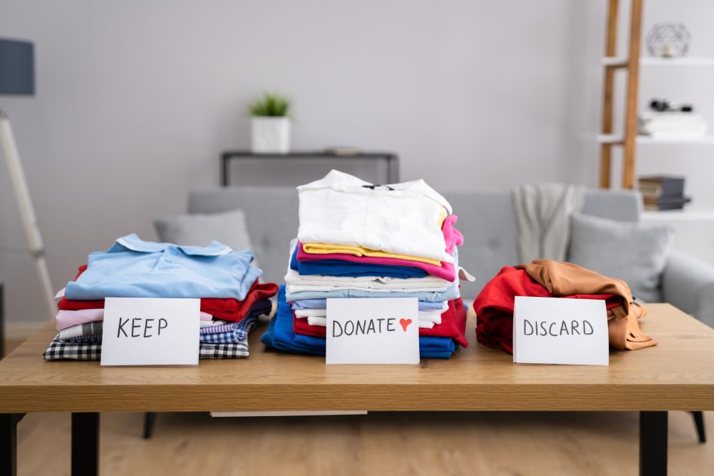 Sorting and decluttering items in an apartment living room.